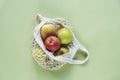 Fresh ripe apples in a string bag on green background. Zero waste, no plastic concept. Top view, flat lay Royalty Free Stock Photo