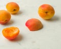 Fresh and ripe apricots on a white stone background. Royalty Free Stock Photo