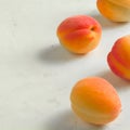 Fresh and ripe apricots on a white stone background. Royalty Free Stock Photo