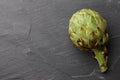 Fresh artichokes close up on textured stone background