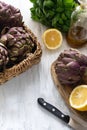 Fresh ripe artichokes and halved lemons