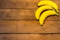 Fresh ripe bananas on a wooden board. Wooden background with bananas and copy text Royalty Free Stock Photo