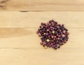 Fresh ripe black grewia asiatica fruit berries on a wooden background