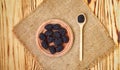 Fresh ripe blackberries in wooden plate and spoon on rustic table, top view Royalty Free Stock Photo