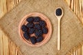 Fresh ripe blackberries in wooden plate and spoon on rustic table, top view Royalty Free Stock Photo