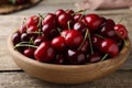Fresh ripe cherries in bowl on wooden table, closeup Royalty Free Stock Photo