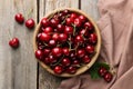 Fresh ripe cherries and towel on wooden table, flat lay Royalty Free Stock Photo