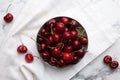 Fresh ripe cherries with water drops on white marble table, flat lay Royalty Free Stock Photo