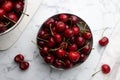 Fresh ripe cherries with water drops on white marble table, flat lay Royalty Free Stock Photo