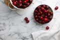 Fresh ripe cherries with water drops on white marble table, flat lay. Space for text Royalty Free Stock Photo