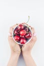 Fresh ripe cherry in a bowl with woman hands Royalty Free Stock Photo