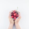 Fresh ripe cherry in a bowl with woman hands Royalty Free Stock Photo