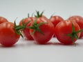 Fresh ripe cherry tomatoes with green star shaped vines Royalty Free Stock Photo