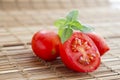 Fresh ripe cherry tomatoes and sweet basil on rustic wooden surface Royalty Free Stock Photo