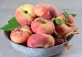 Fresh ripe chinese flat saturn peaches with leaves Royalty Free Stock Photo