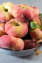 Fresh ripe chinese flat saturn peaches with leaves Royalty Free Stock Photo