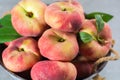 Fresh ripe chinese flat saturn peaches with leaves Royalty Free Stock Photo