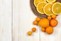 Fresh ripe citrus. Lemons, kumquat and oranges on wooden table Royalty Free Stock Photo