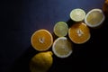 Fresh ripe citruses. Lemons, limes and oranges on dark stone background. Top view Royalty Free Stock Photo