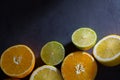 Fresh ripe citruses. Lemons, limes and oranges on dark stone background. Top view Royalty Free Stock Photo