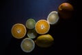 Fresh ripe citruses. Lemons, limes and oranges on dark stone background. Top view Royalty Free Stock Photo