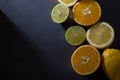 Fresh ripe citruses. Lemons, limes and oranges on dark stone background. Top view Royalty Free Stock Photo