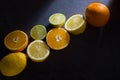 Fresh ripe citruses. Lemons, limes and oranges on dark stone background. Top view Royalty Free Stock Photo