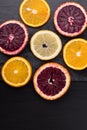 Fresh ripe citruses. Lemons, red oranges and oranges on dark stone background. Copy space Royalty Free Stock Photo