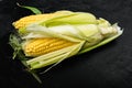 Fresh ripe corn cobs, on black background Royalty Free Stock Photo