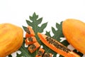 Fresh ripe cut and whole papaya fruits with leaf on white background. Space for text Royalty Free Stock Photo