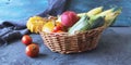 Fresh ripe diverse vegetables and fruits in a basket, on a dark background, organic natural food Royalty Free Stock Photo