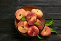 Fresh ripe donut peaches on black wooden table, flat lay Royalty Free Stock Photo