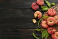 Fresh ripe donut peaches on black wooden table, flat lay. Space for text Royalty Free Stock Photo