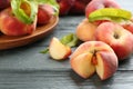 Fresh ripe donut peaches on grey wooden table, closeup. Space for text Royalty Free Stock Photo