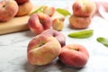 Fresh ripe donut peaches on white marble table, closeup Royalty Free Stock Photo
