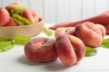 Fresh ripe donut peaches on white wooden table, closeup Royalty Free Stock Photo