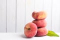 Fresh ripe donut peaches on white wooden table. Space for text Royalty Free Stock Photo