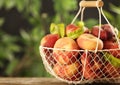 Fresh ripe donut peaches on wooden table against blurred green background, closeup. Royalty Free Stock Photo