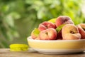 Fresh ripe donut peaches on wooden table against blurred green background, closeup. Space for text Royalty Free Stock Photo