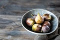 Fresh ripe figs in a bowl on a dark wooden table. selective focus. Copy space