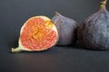 Fresh ripe figs on dark table. Healthy mediterranean fig fruit. Fresh figs on black background. Royalty Free Stock Photo
