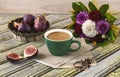 Fresh ripe figs on vintage plate, green cup of coffee, bouquet of burgundy dahlias, vintage scissors and purple shawl as decor.