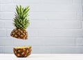 Fresh ripe flying cut juicy pineapple on gray brick wall background Royalty Free Stock Photo