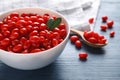 Fresh ripe goji berries in bowl on blue wooden table Royalty Free Stock Photo