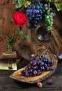 Fresh ripe grapes. Grape harvest. Handmade wooden utensils on the kitchen table. Wooden plates, bowls and dishes on the table. Royalty Free Stock Photo