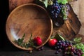 Fresh ripe grapes. Grape harvest. Handmade wooden utensils on the kitchen table. Wooden plates, bowls and dishes on the table. Royalty Free Stock Photo