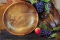 Fresh ripe grapes. Handmade wooden utensils on the kitchen table. Wooden plates, bowls and dishes on the table. Royalty Free Stock Photo