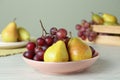 Fresh ripe grapes and pears on white wooden table Royalty Free Stock Photo