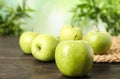 Fresh ripe green apples on dark wooden table against blurred background Royalty Free Stock Photo