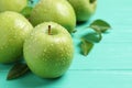 Fresh ripe green apples with water drops on turquoise wooden table, closeup Royalty Free Stock Photo